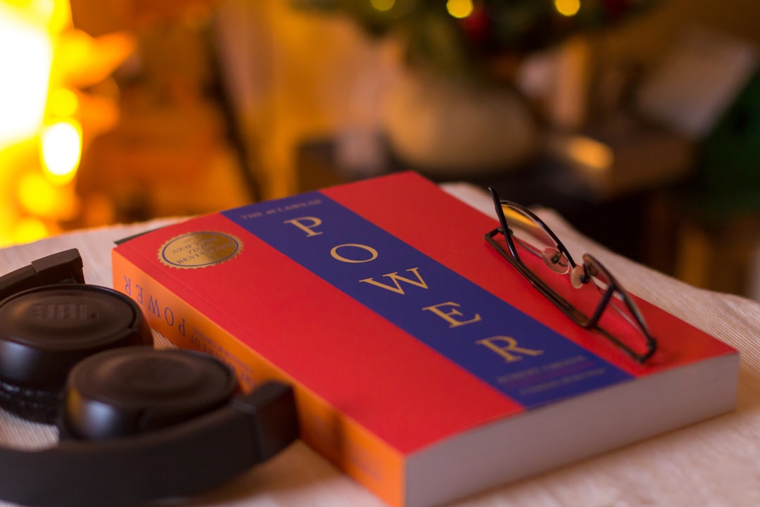 Photo by János Venczák A pair of glasses sitting on top of a book